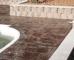 stamped concrete pool deck with interlock wall
